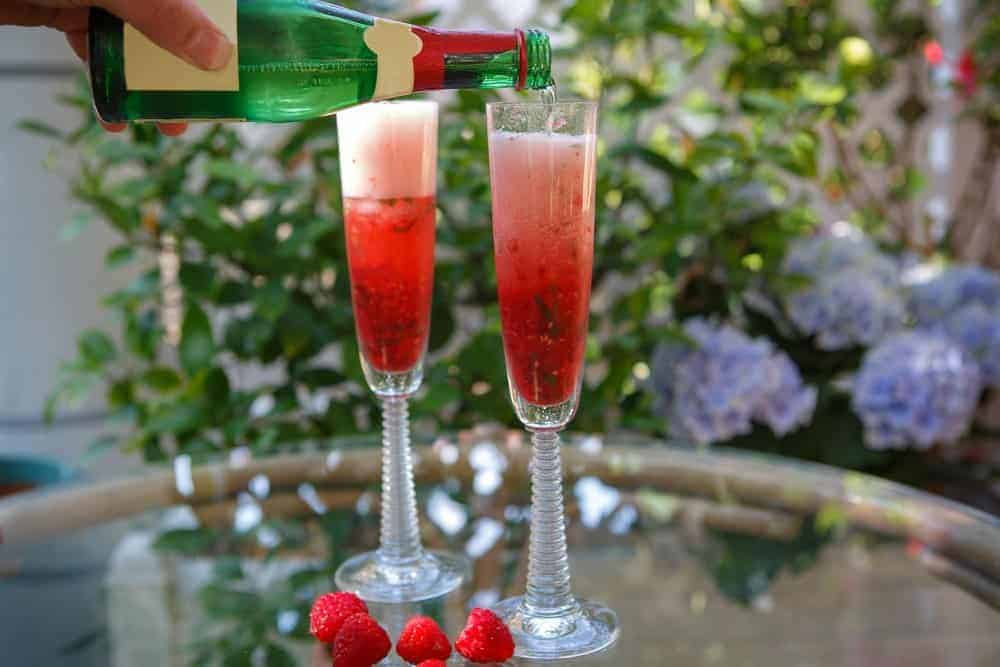 Summer cocktail with champagne and fresh raspberries