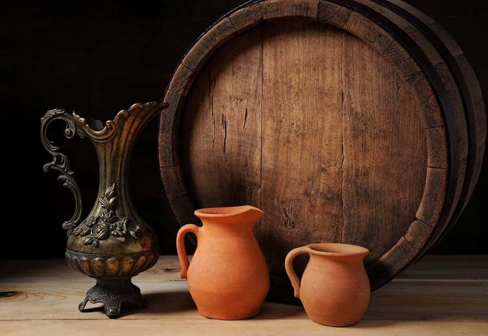 Barrel with metal jug and pots