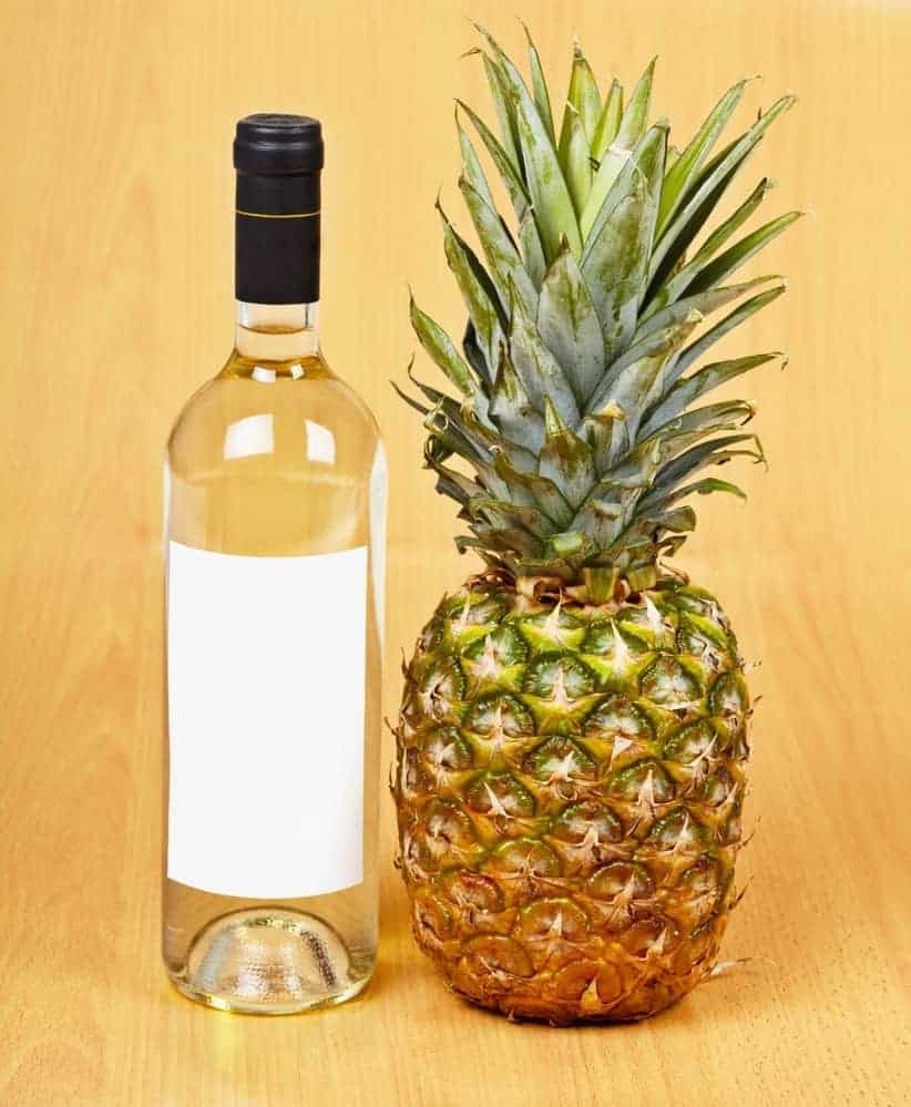 Bottle of white wine and large pineapple