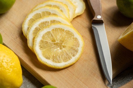 Close up view of sliced lemon on wooden cutting board