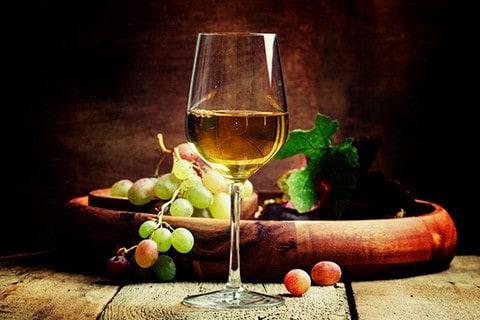 white wine in a glass with grapes
