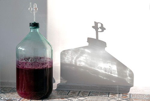 Carboy containing red wine