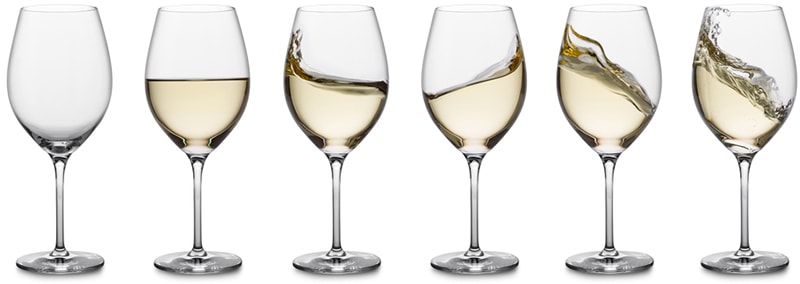 white wines lines up in glasses