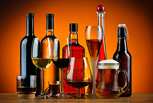 Various types of alcoholic drinks in bottles and glasses