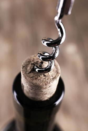 Opening a bottle of wine with a corkscrew