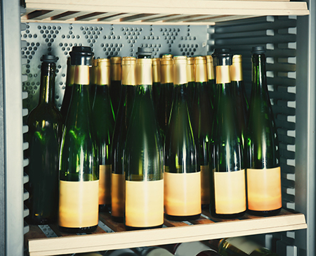 Open wine bottles in a fridge