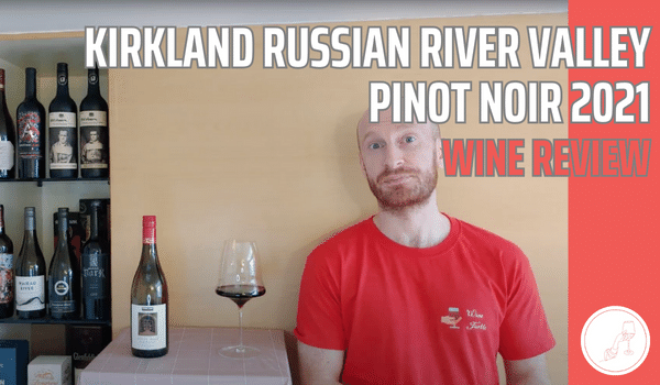 Jamie standing with Kirkland Russian River Valley Pinot Noir 2021